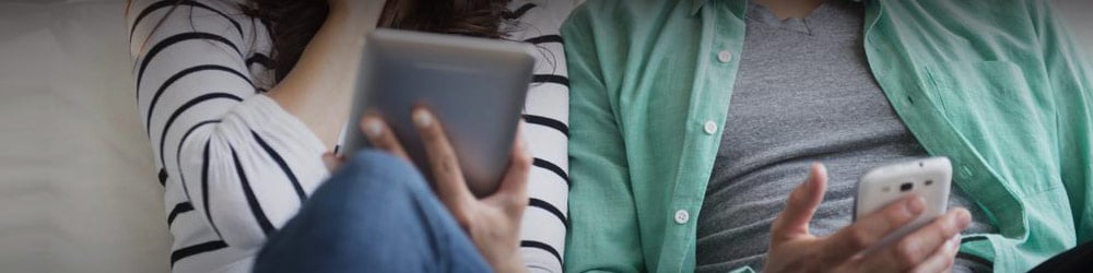 Couple looking at their mobile devices