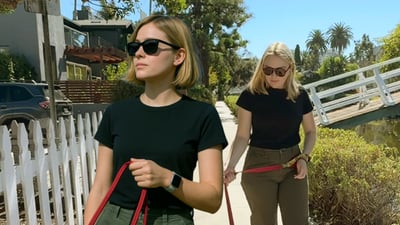 Two woman in sunglasses dog walking