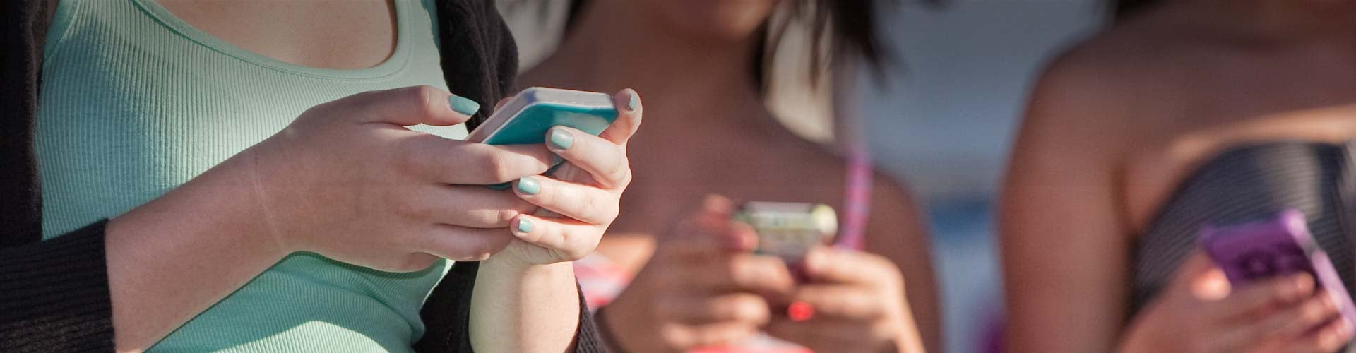 A group of girls viewing their phones